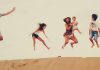 Family enjoying the dunes in the merzouga desert during their Morocco vacation