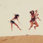 Family enjoying the dunes in the merzouga desert during their Morocco vacation
