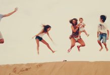 Family enjoying the dunes in the merzouga desert during their Morocco vacation