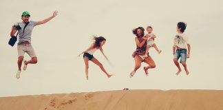 Family enjoying the dunes in the merzouga desert during their Morocco vacation