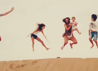 Family enjoying the dunes in the merzouga desert during their Morocco vacation