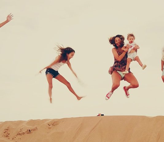 Family enjoying the dunes in the merzouga desert during their Morocco vacation