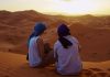 Romantic Couple Observing the Moroccan Sahara Desert Sunset